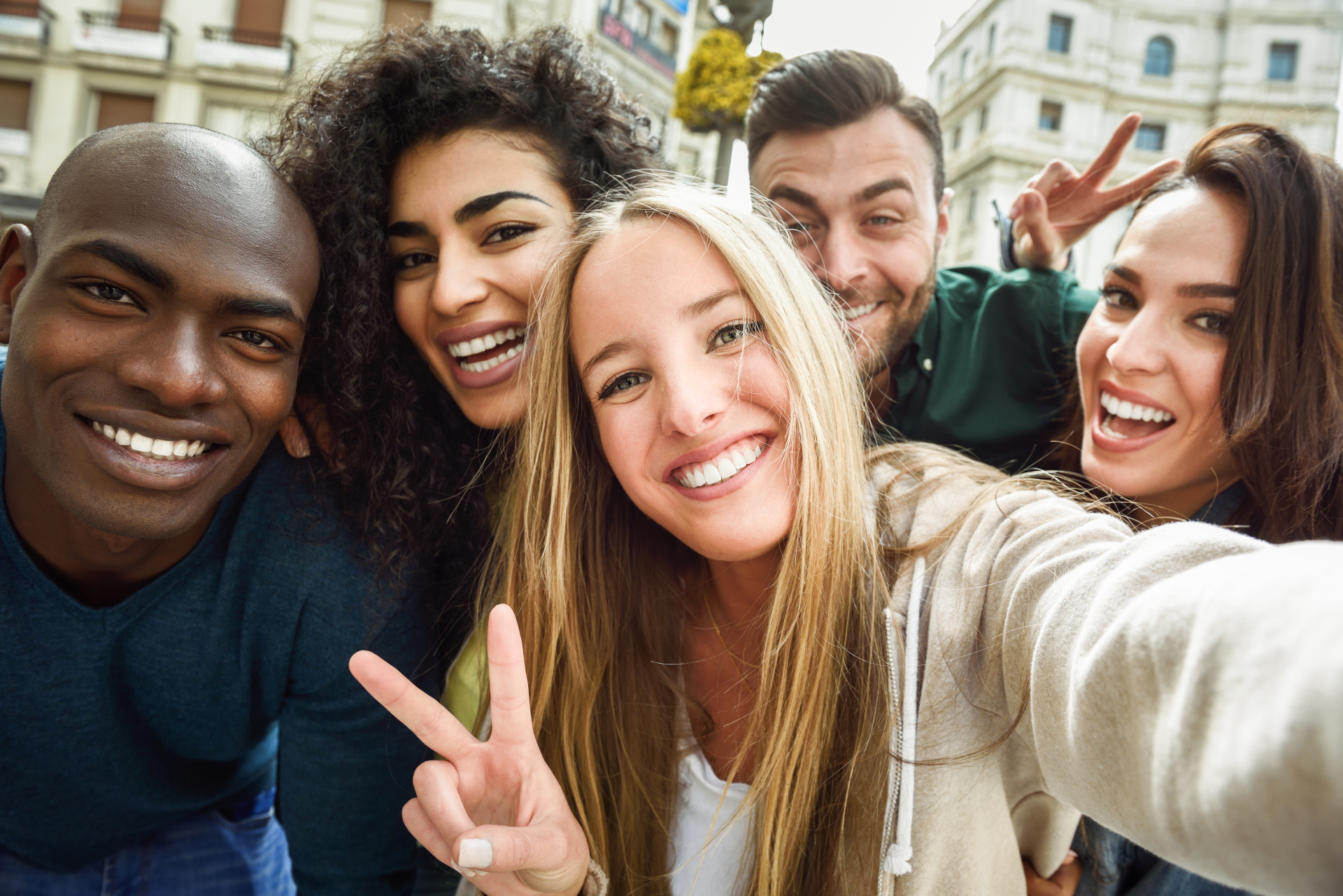 Diverse group of happy adults showing confident smiles after orthodontic treatment