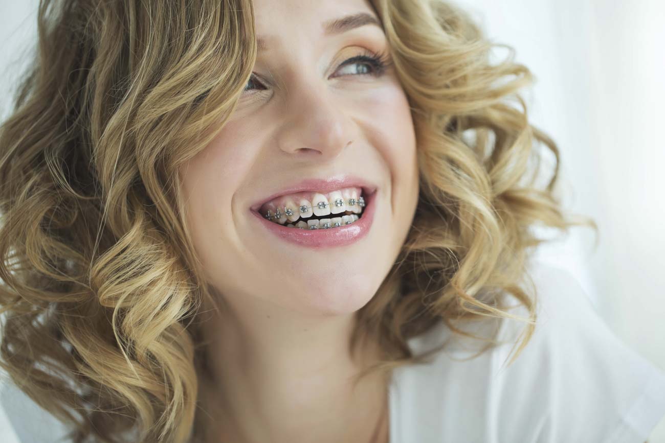 adult wearing clear Portland dental braces