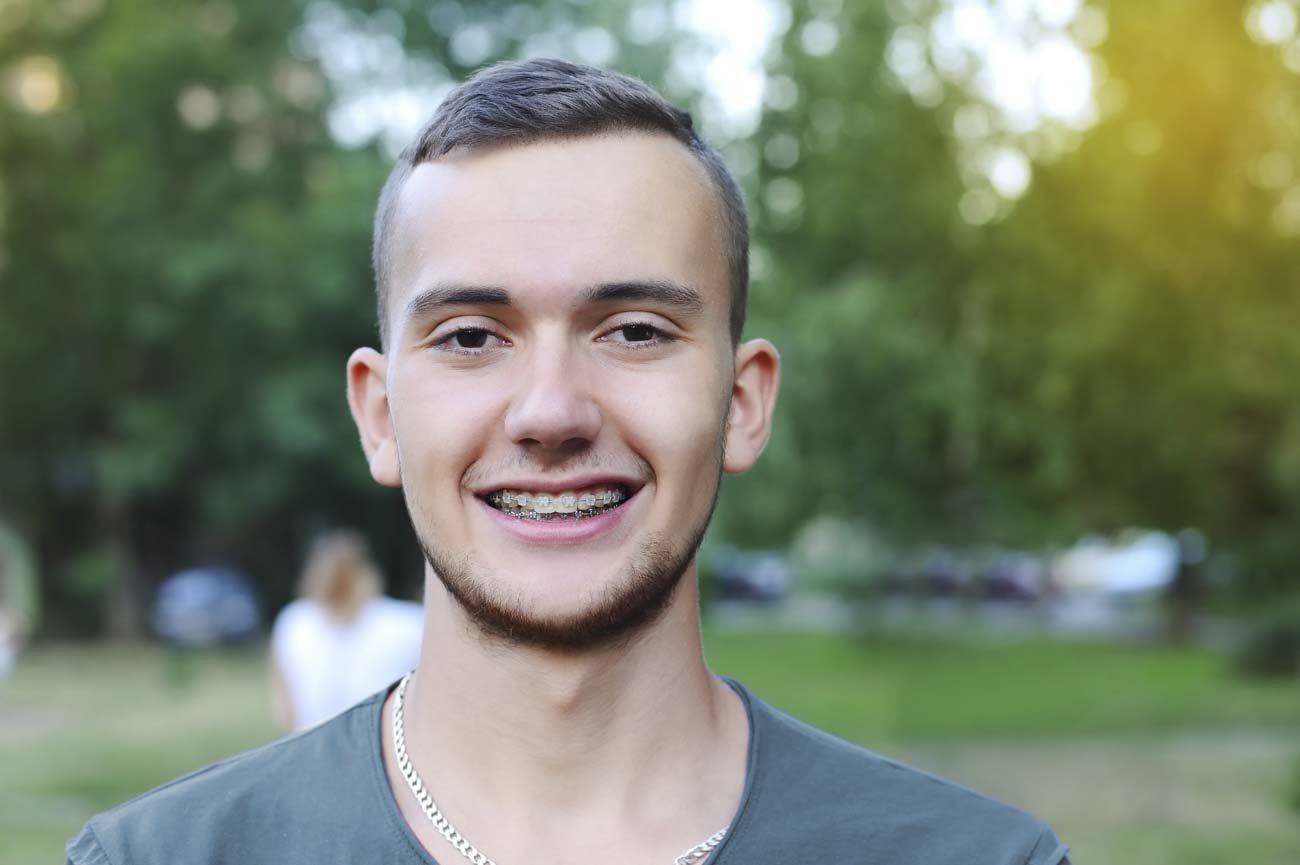teen showing Portland dental braces after adjustment
