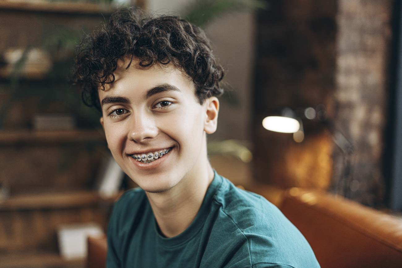 teen boy with braces smiling