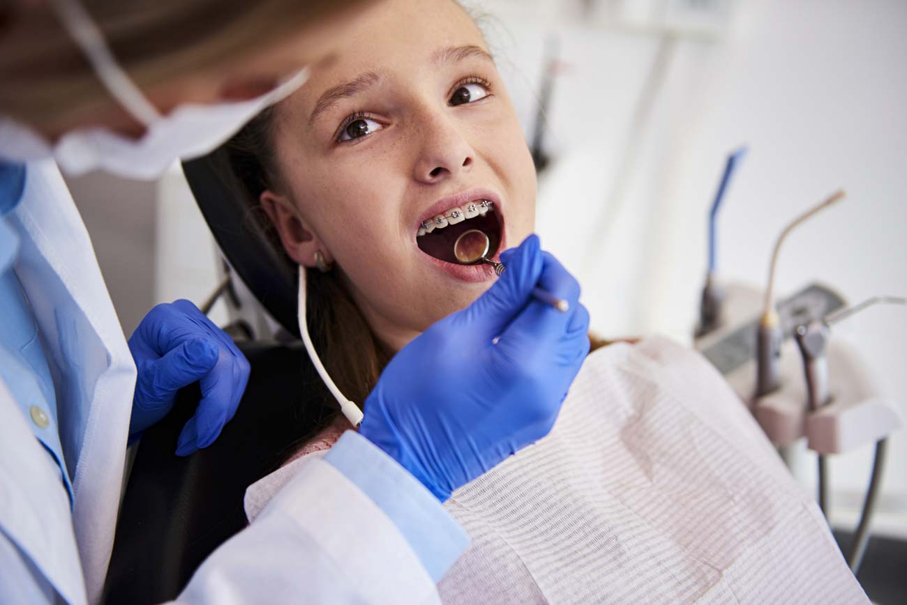 teen using Portland dental braces during orthodontic treatment