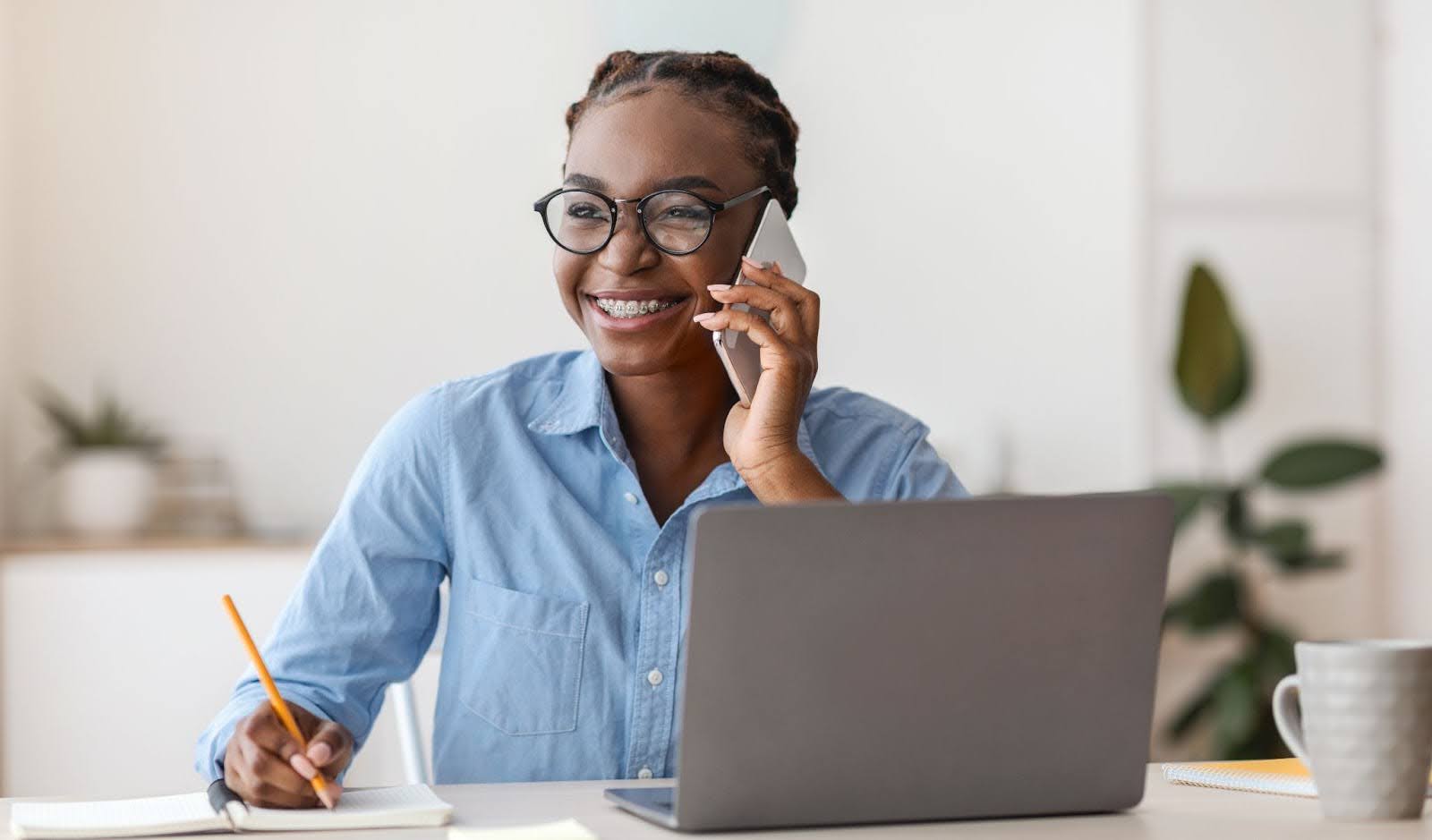 woman with braces on the phone and smiling